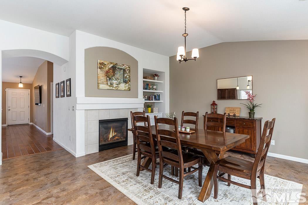 9778 Thunder Mountain Way Reno, NV 89521 - Photo 11 of 21 a view of a dining room with furniture wooden floor and a chandelier