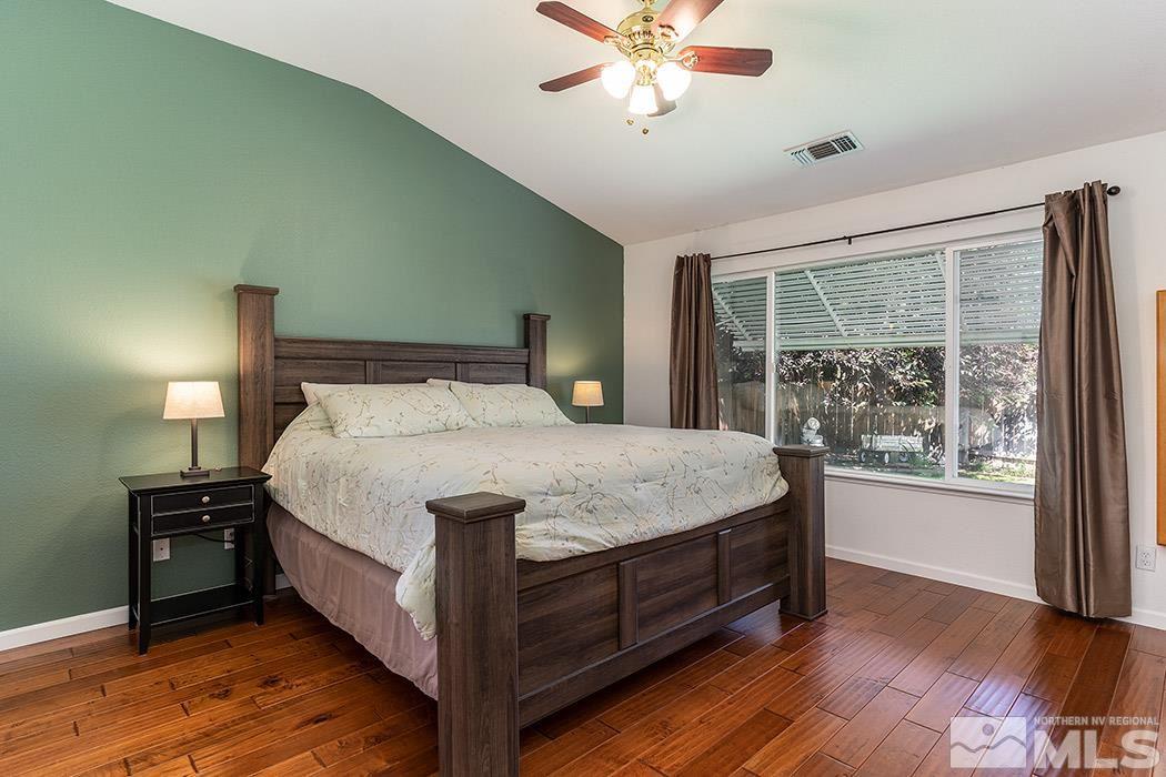 9778 Thunder Mountain Way Reno, NV 89521 - Photo 13 of 21 a large bed sitting in a bedroom next to a window
