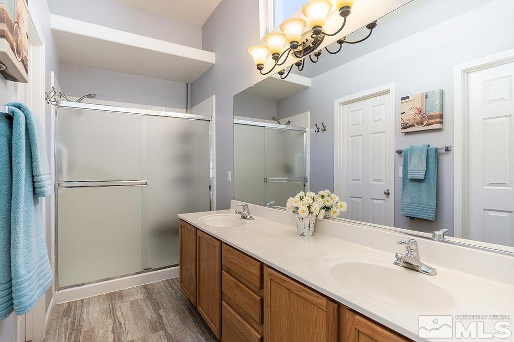 9778 Thunder Mountain Way Reno, NV 89521 - Photo 14 of 21 a bathroom with a sink double vanity and mirror