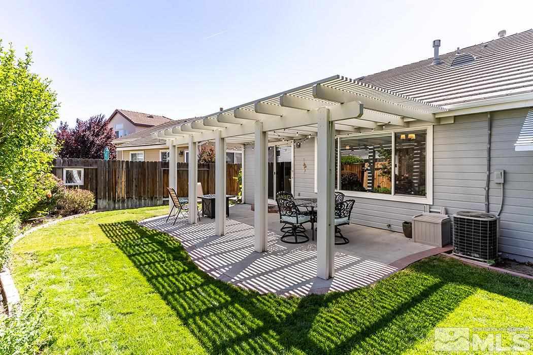 9778 Thunder Mountain Way Reno, NV 89521 - Photo 19 of 21 a view of a house with a yard patio and fire pit