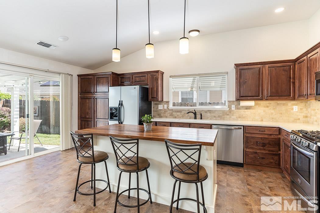 9778 Thunder Mountain Way Reno, NV 89521 - Photo 8 of 21 a large kitchen with a table and chairs in it