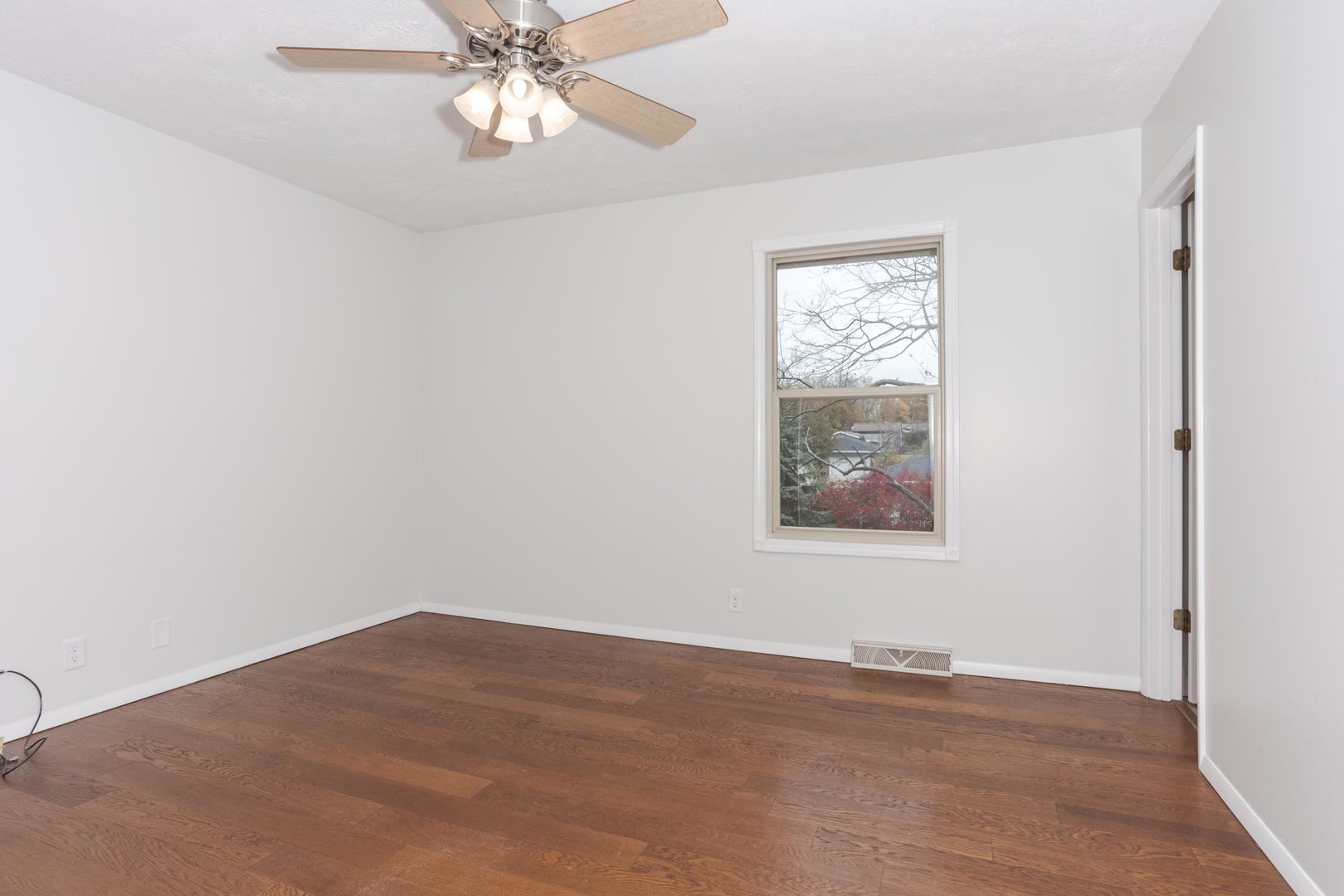 1308 Schroeder Drive Normal, IL 61761 - Photo 18 of 55 a view of an empty room with wooden floor and a window