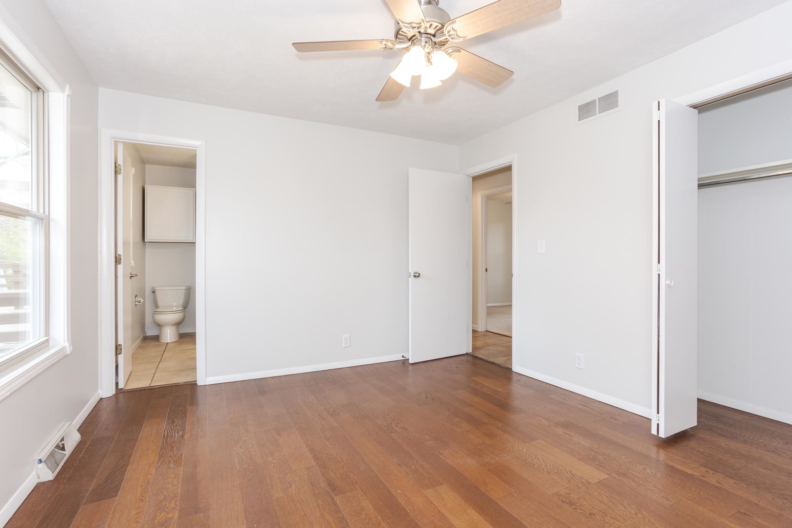 1308 Schroeder Drive Normal, IL 61761 - Photo 19 of 55 a view of an empty room with wooden floor and a window