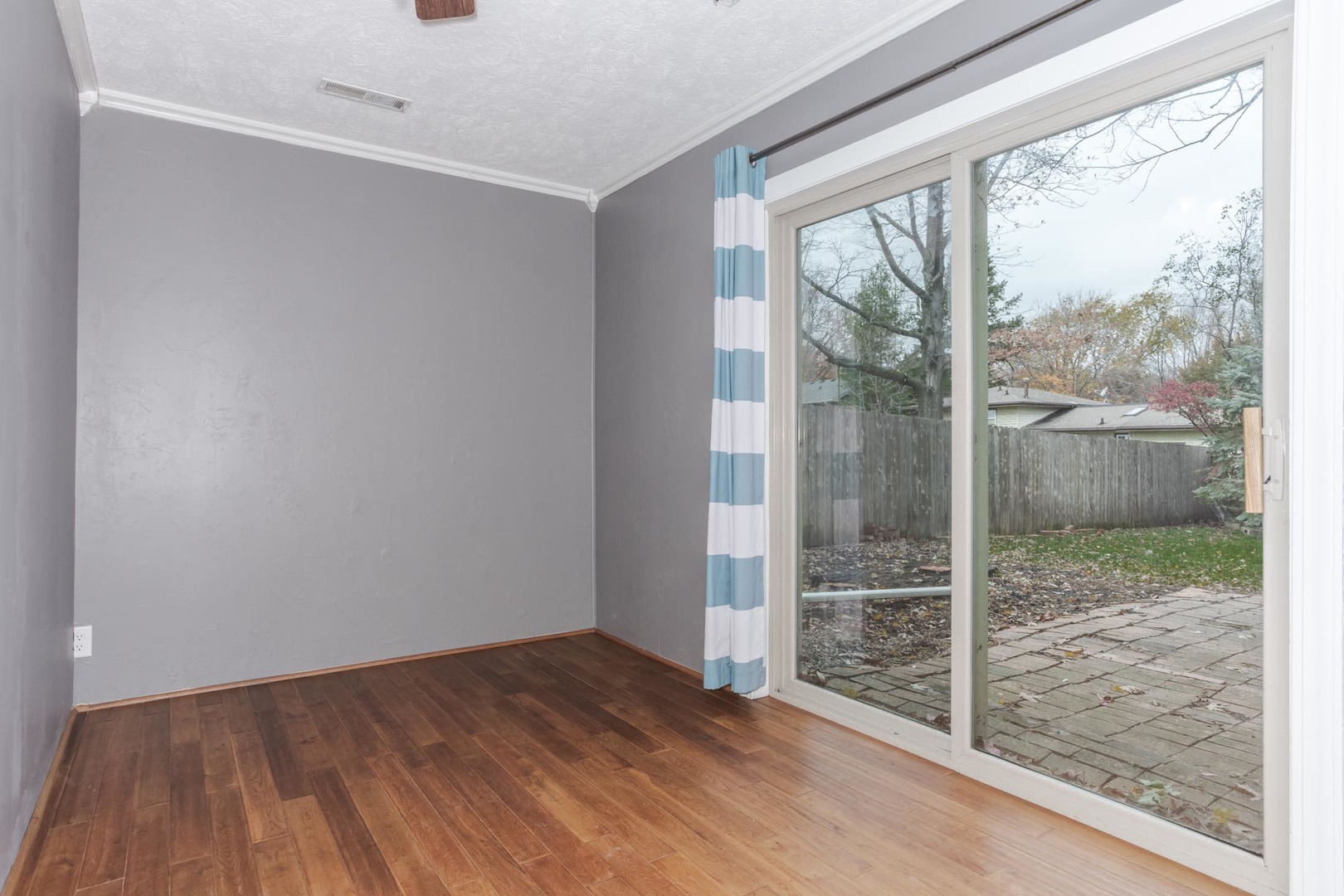 1308 Schroeder Drive Normal, IL 61761 - Photo 33 of 55 a view of a room with wooden floor and a floor to ceiling window