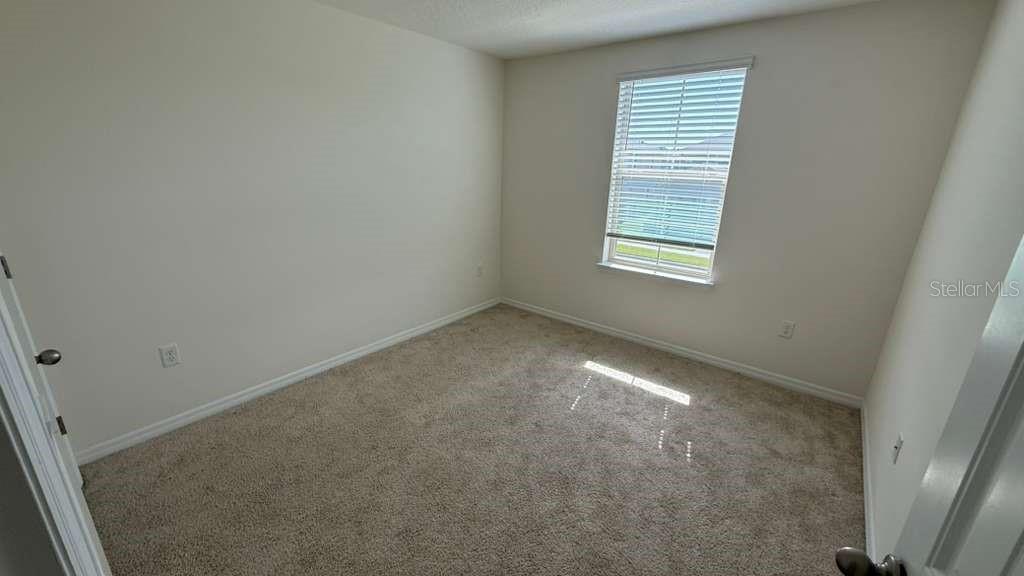 17061 Water Spring Boulevard Winter Garden, FL 34787 - Photo 13 of 17 an empty room with a window