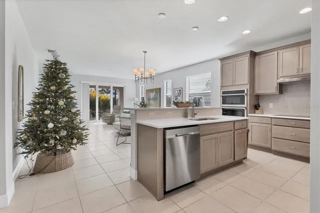 a living room with furniture a chandelier and a rug