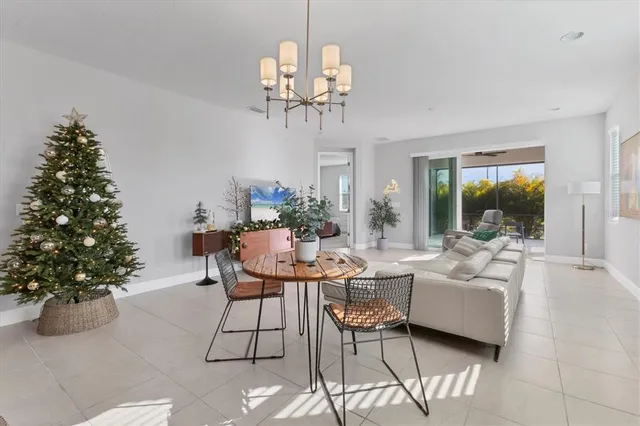 a kitchen with kitchen island a table and chairs in it