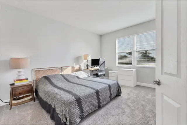 a bedroom with a bed and window