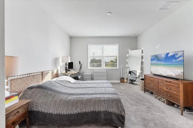 a bedroom with furniture and a window