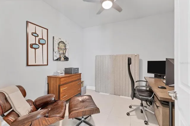 a view of a workspace with furniture and a window