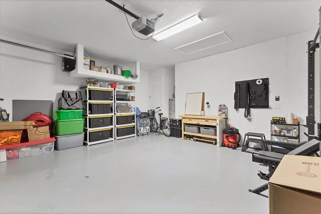 a view of a room with a bed and wooden floor