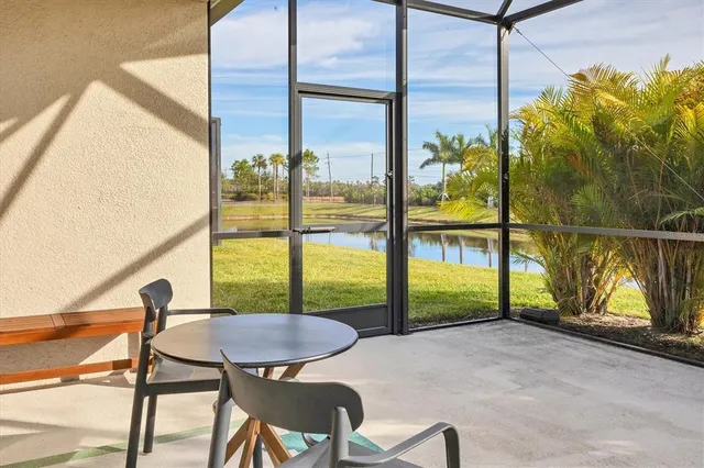 a view of a porch with furniture and floor to ceiling windows