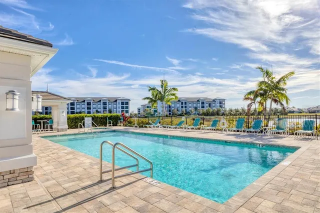 a view of a house with backyard and sitting area