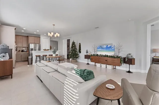 a living room with furniture and a chandelier