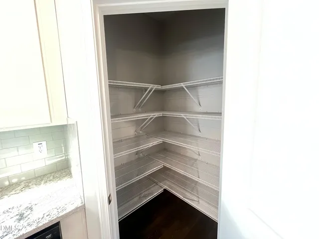 a kitchen with kitchen island wooden floors appliances and cabinets