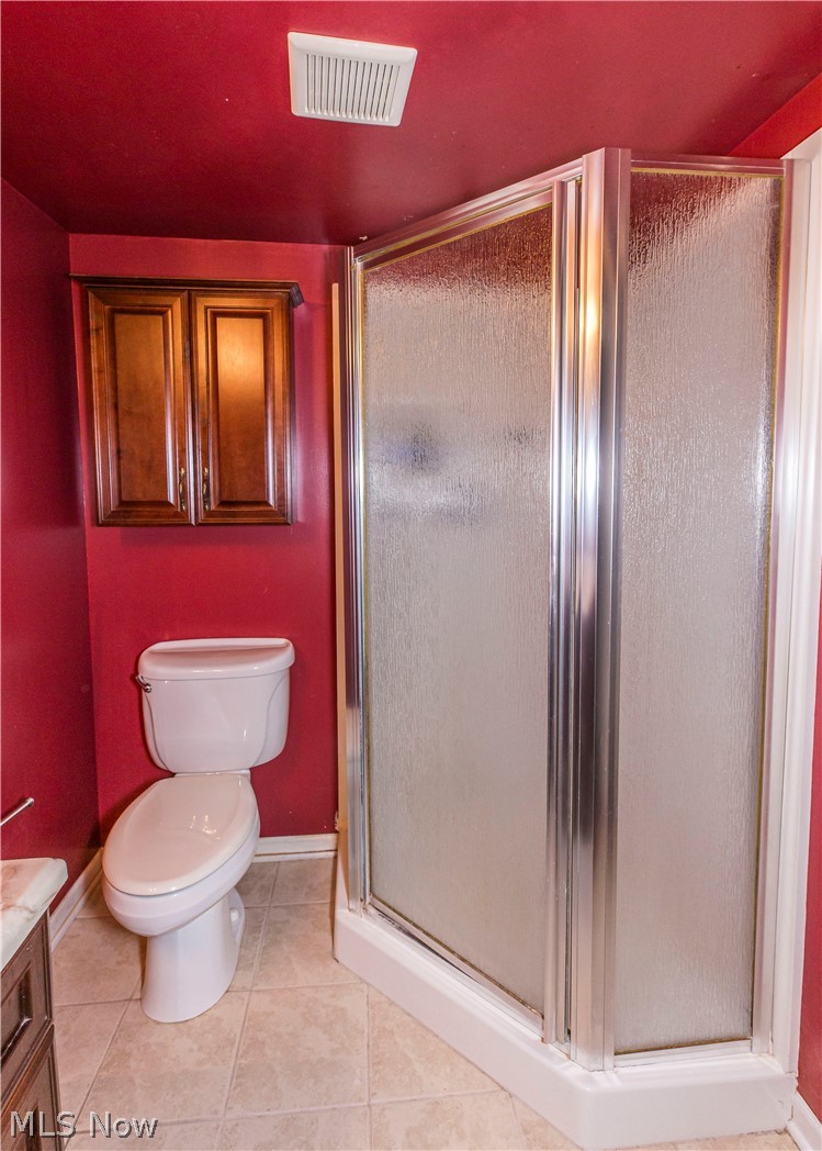 6203 Snow Road Parma, OH 44129 - Photo 20 of 29 Bathroom with vanity, toilet, tile floors, and a shower with door