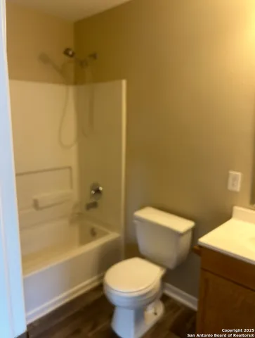 a white toilet sitting next to a bath tub