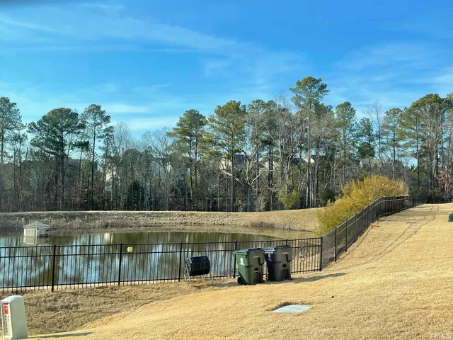 a view of a swimming pool and trees in the background