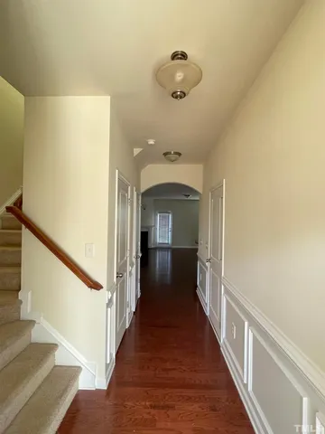 a view of a hallway view with wooden floor and staircase