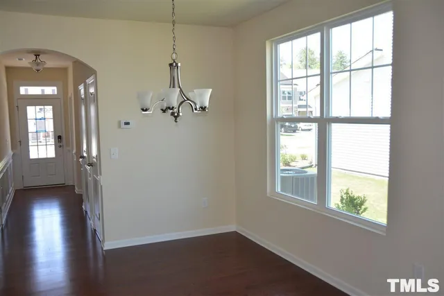 a view of a room with wooden floor and windows