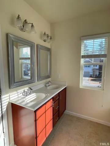 a bathroom with a sink double vanity and a mirror