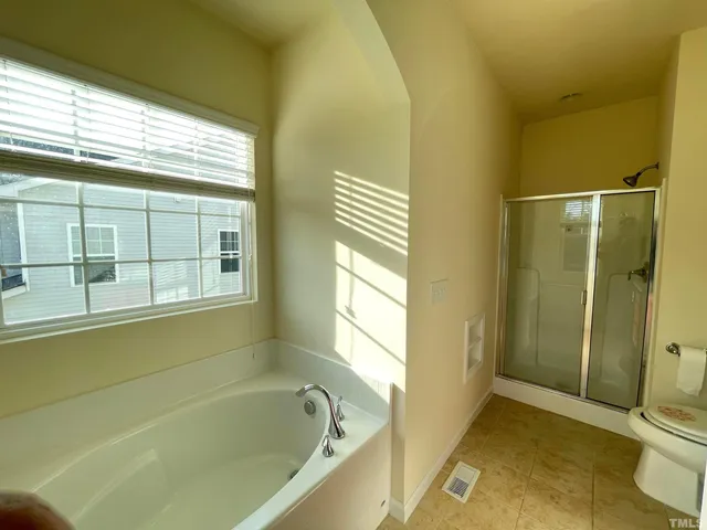 a bathroom with a bathtub and shower
