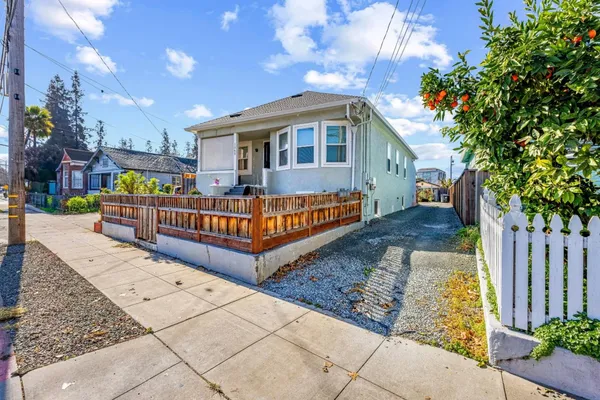 a view of a house with wooden fence
