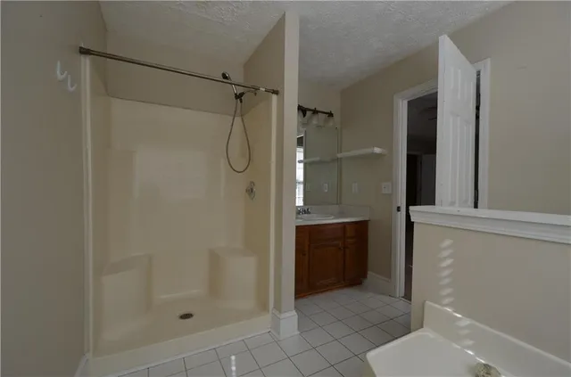 a bathroom with a shower and a sink