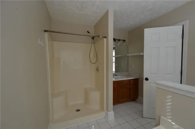a bathroom with a shower and a sink