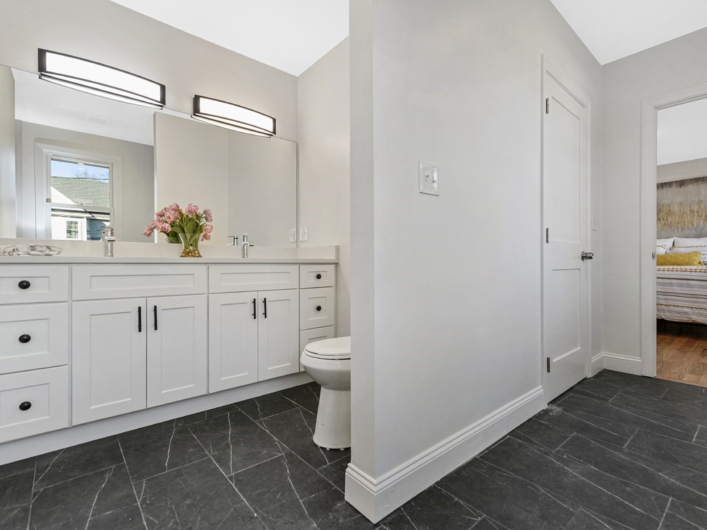33 Line Road Reading, MA 01867 - Photo 11 of 23 a spacious bathroom with a sink a toilet and a mirror