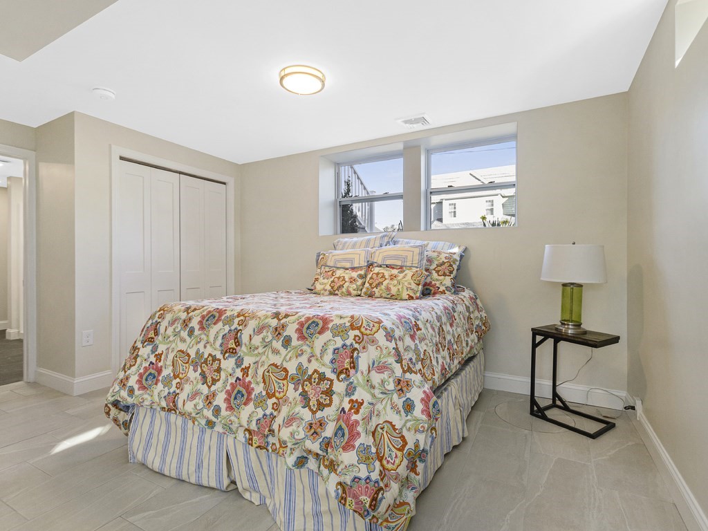 33 Line Road Reading, MA 01867 - Photo 15 of 23 a bedroom with a bed and a lamp on table