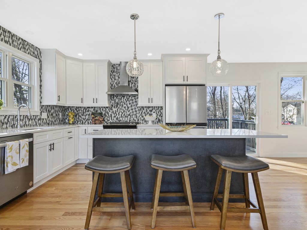 33 Line Road Reading, MA 01867 - Photo 2 of 23 a kitchen with a table chairs stove and cabinets