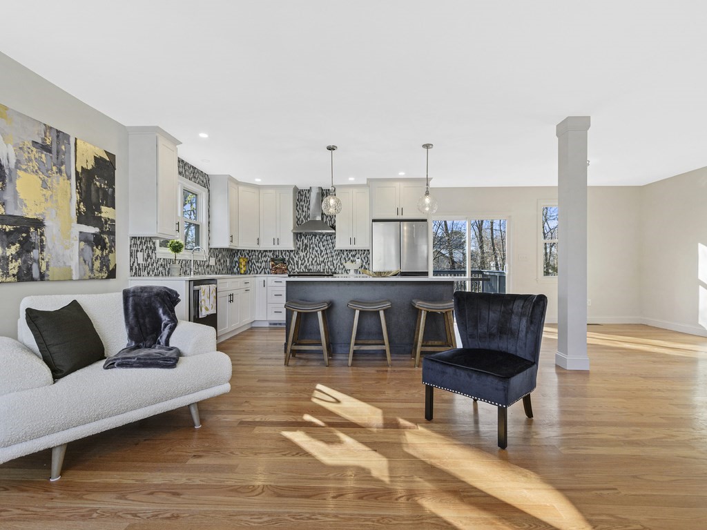 33 Line Road Reading, MA 01867 - Photo 6 of 23 a living room with stainless steel appliances furniture a rug and a kitchen view