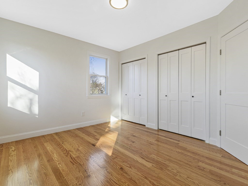 33 Line Road Reading, MA 01867 - Photo 7 of 23 a view of an empty room with wooden floor