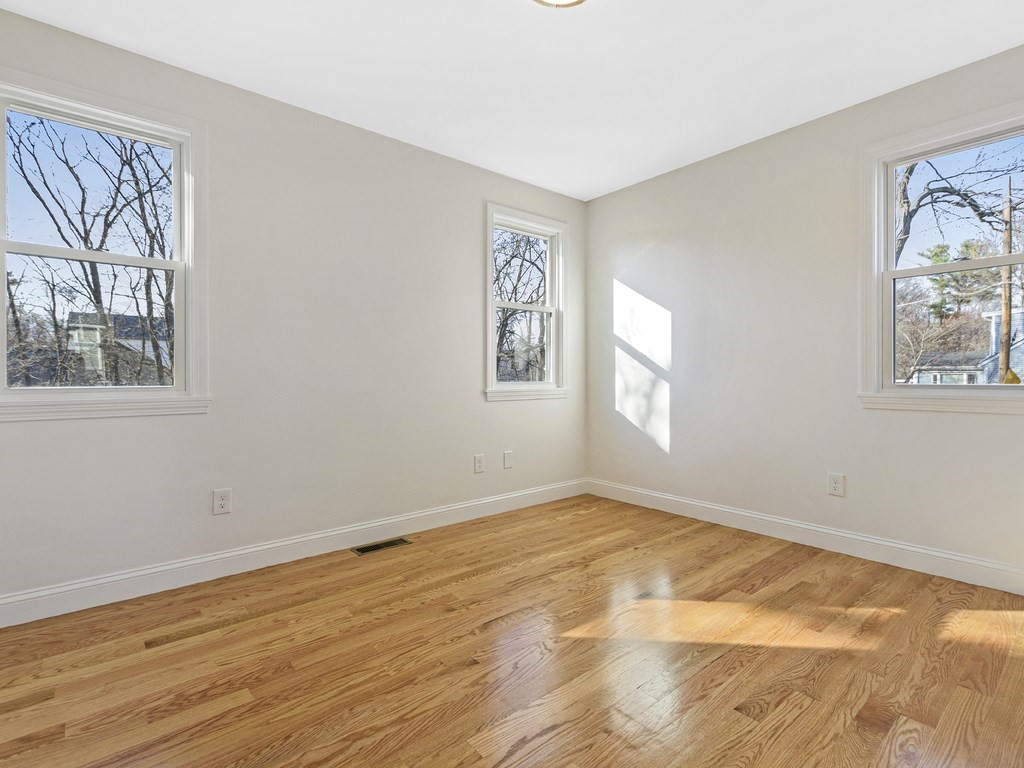 33 Line Road Reading, MA 01867 - Photo 8 of 23 a view of empty room with wooden floor and fan