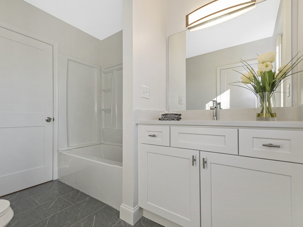 33 Line Road Reading, MA 01867 - Photo 9 of 23 a bathroom with a sink a mirror and a potted plant