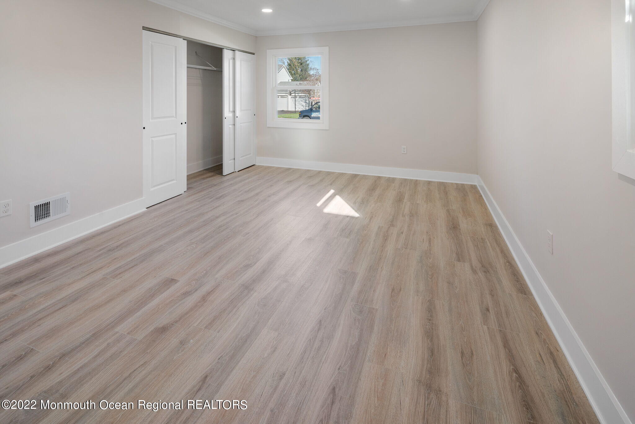 46 Beacon Lane Aberdeen, NJ 07747 - Photo 17 of 27 an empty room with wooden floor closet and windows