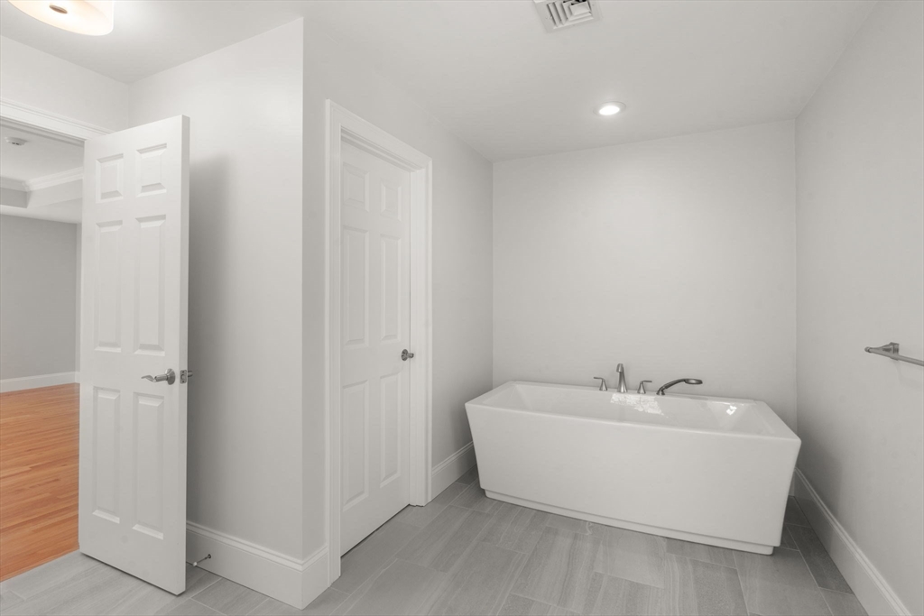 173 Benvenue Street Wellesley, MA 02482 - Photo 18 of 34 a white bath tub sitting in a bathroom