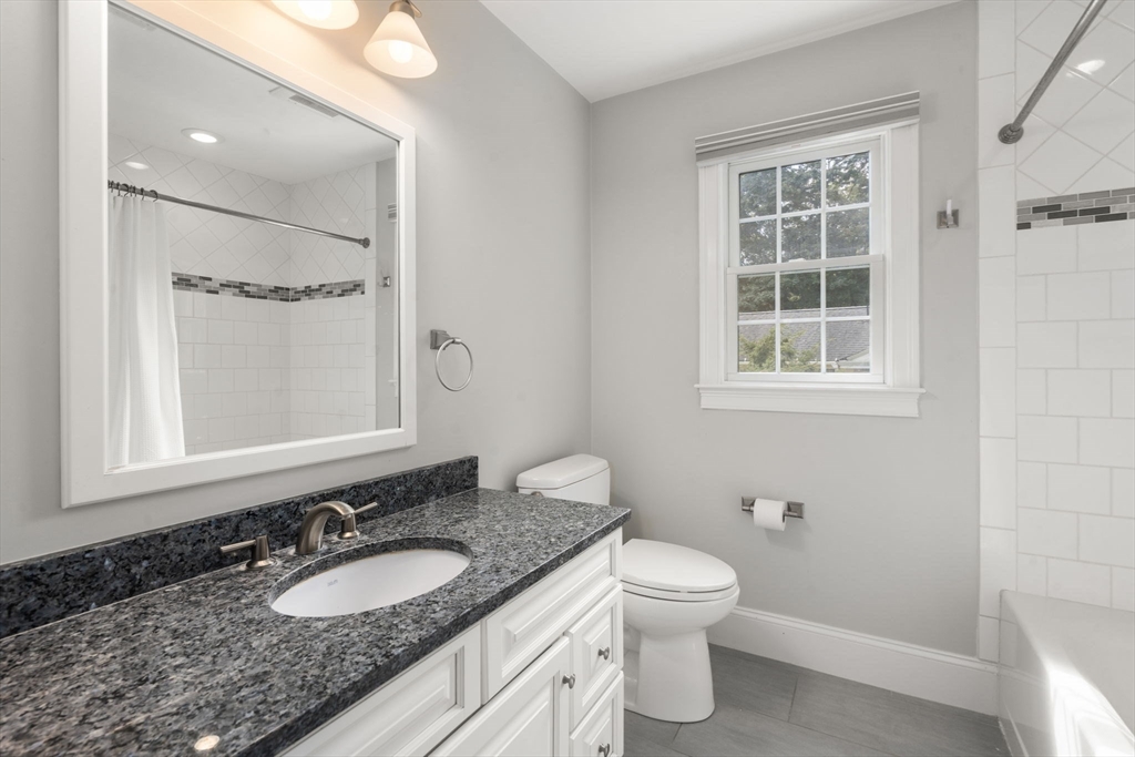 173 Benvenue Street Wellesley, MA 02482 - Photo 24 of 34 a bathroom with a granite countertop toilet a sink and a mirror