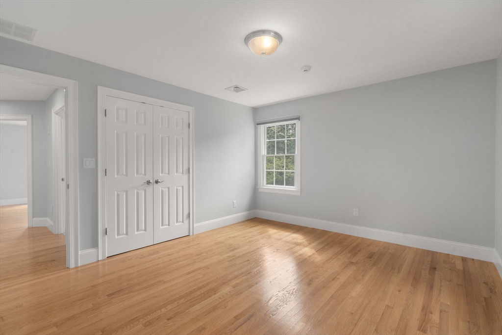 173 Benvenue Street Wellesley, MA 02482 - Photo 25 of 34 a view of an empty room with wooden floor and a window