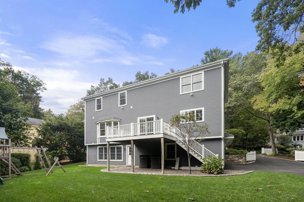 173 Benvenue Street Wellesley, MA 02482 - Photo 32 of 34 a view of house with a big yard and large trees
