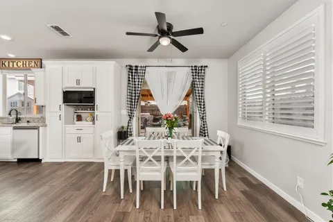 a living room with furniture kitchen view and a potted plant