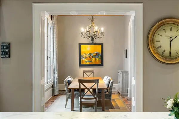 a view of a dining room with furniture and a chandelier