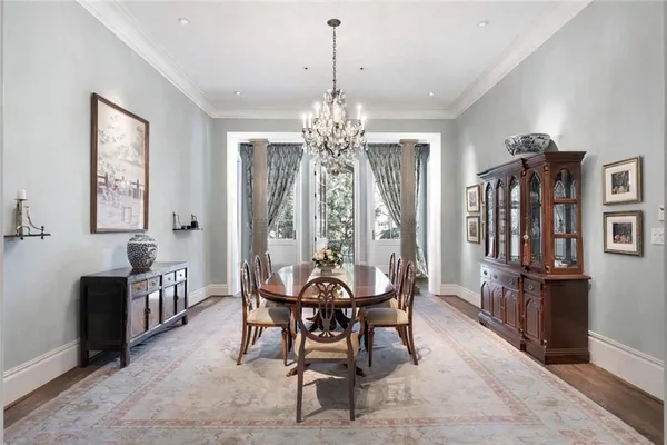 a view of a dining room with furniture and chandelier