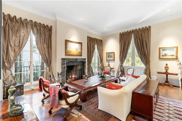 a living room with furniture fireplace and a large window