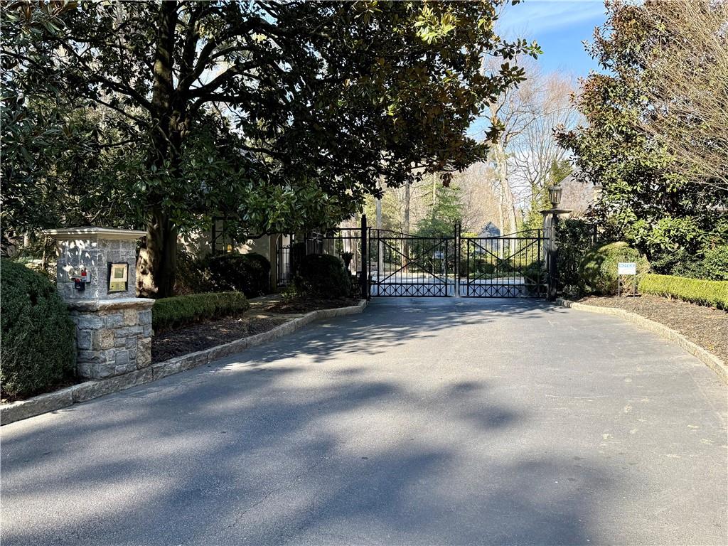 675 West Paces Ferry Road Northwest, Unit 10 Atlanta, GA 30327 - Photo 2 of 47 a view of a street with trees on both side of it