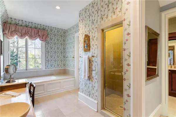 a bathroom with a tub and shower