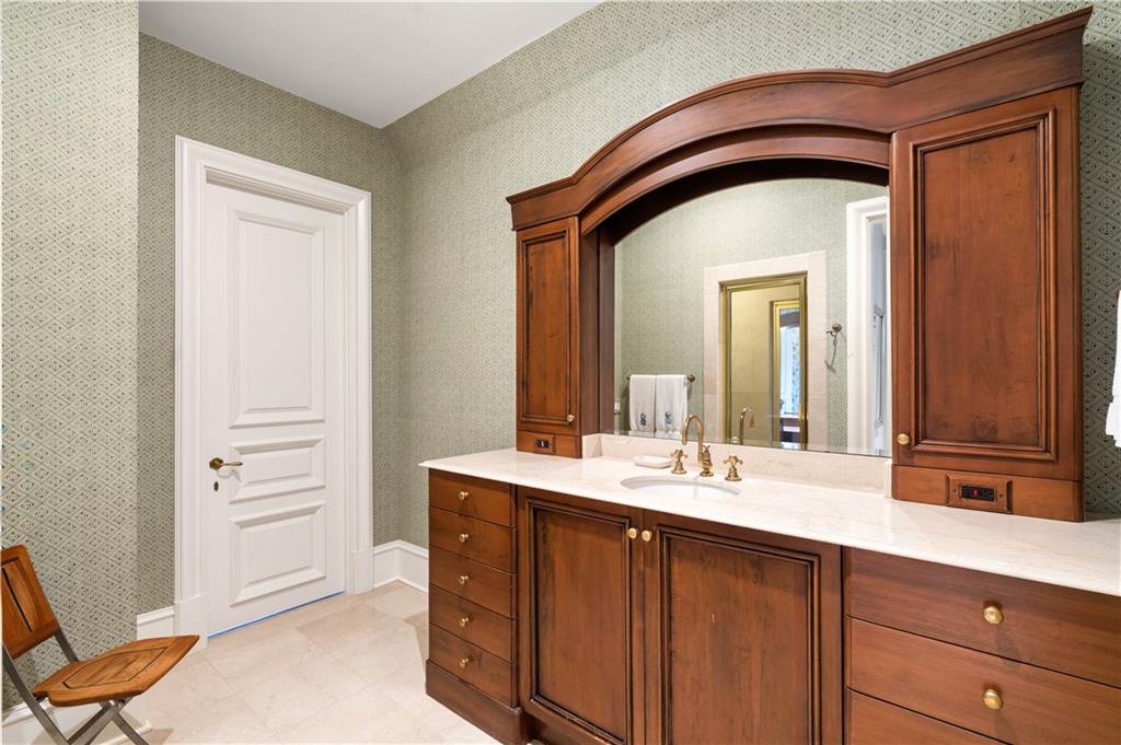 675 West Paces Ferry Road Northwest, Unit 10 Atlanta, GA 30327 - Photo 30 of 47 a bathroom with a double vanity sink and a mirror