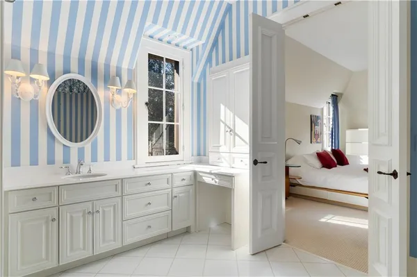a en suite bathroom with a sink and a mirror