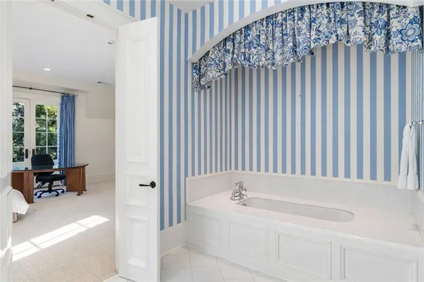 a bathroom with a bathtub and a window